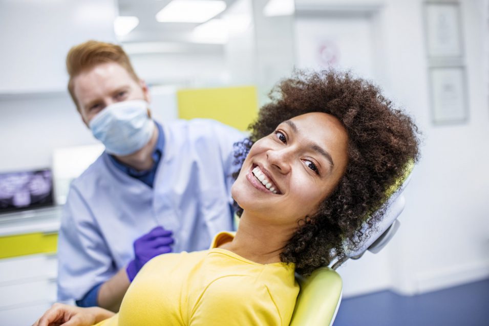 Woman smiling during dental exam checkup in Brantford