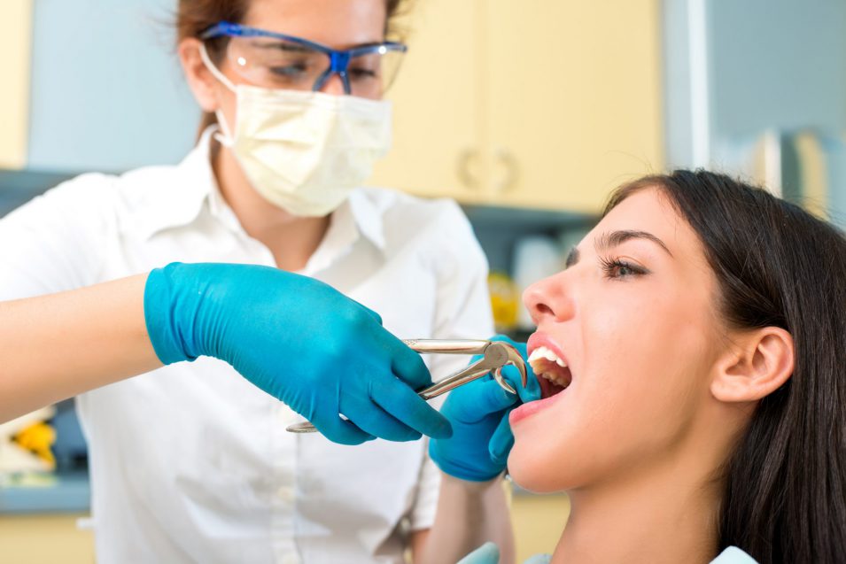 Woman is having a tooth extraction in Brantford