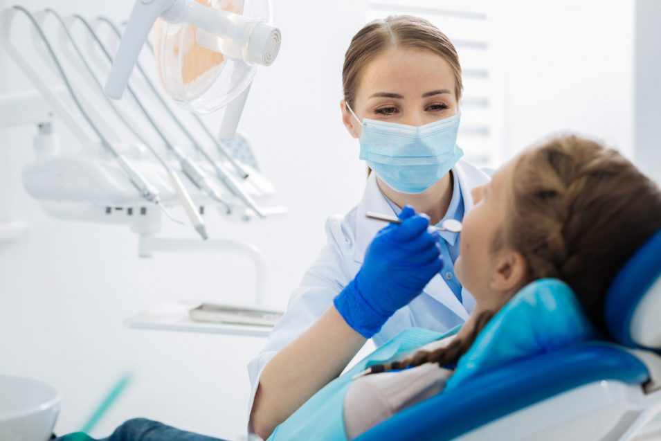 Positive female dentist being at work