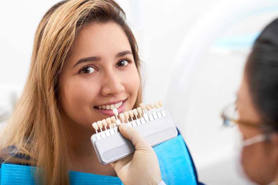 Young woman visiting doctor for teeth whitening