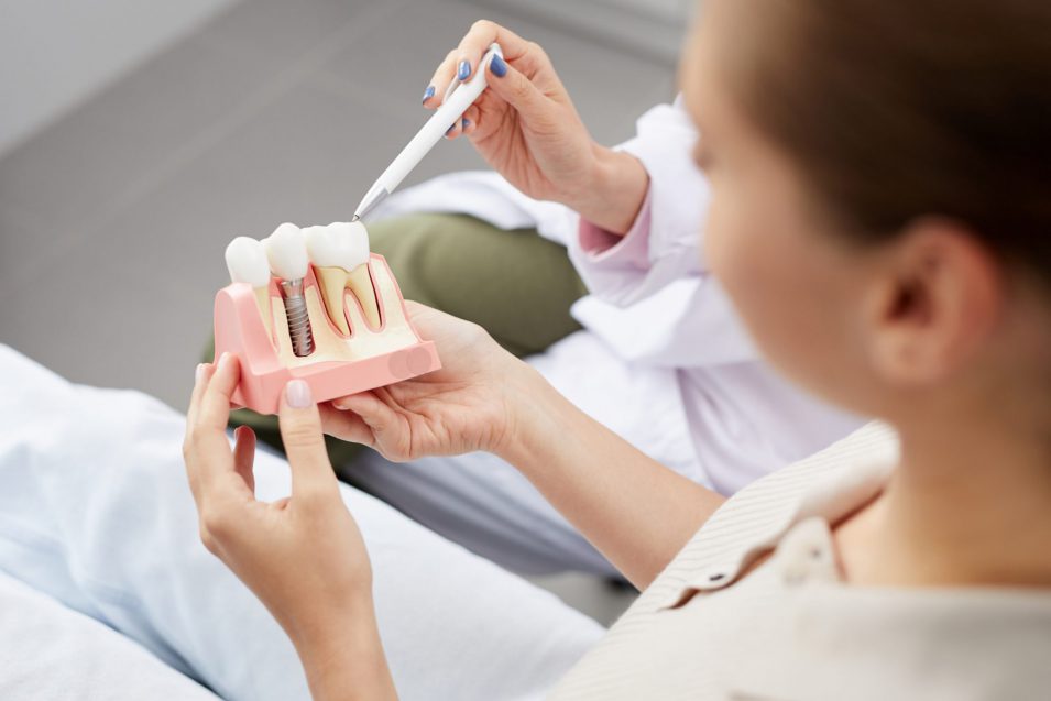 dentist explaing the dental crown procedure to patient