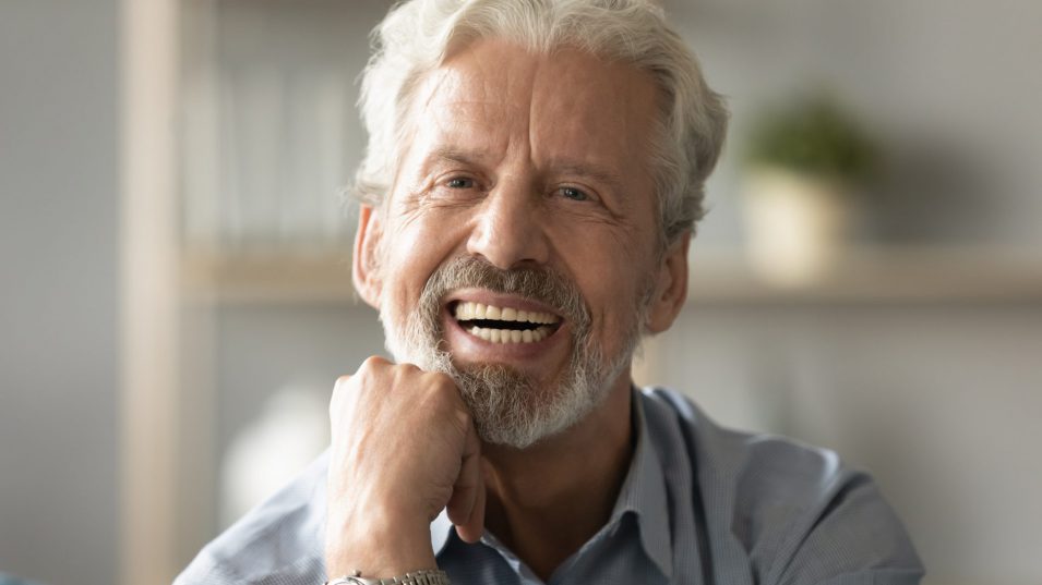 Portrait elderly man with candid wide smile looking at camera dentures in brantford