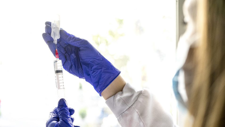 Midsection Of Female Nurse Holding Syringe Against White Background Midsection Of Female Nurse Holding Syringe Against White Background before administering IV sedation dentistry in Brantford