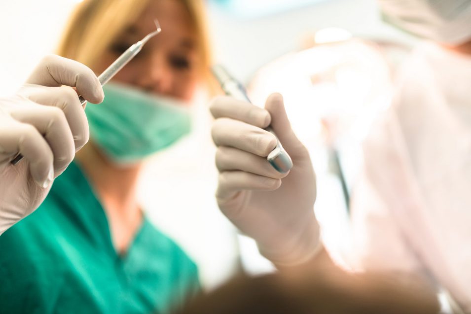 assistant at the dentist clinic Dentist in Brampton working on an Emergency Dentistry case at Avenue Dental