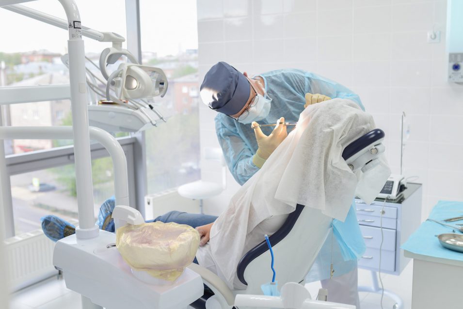 Emergency dentist performs dental surgery in clinic
